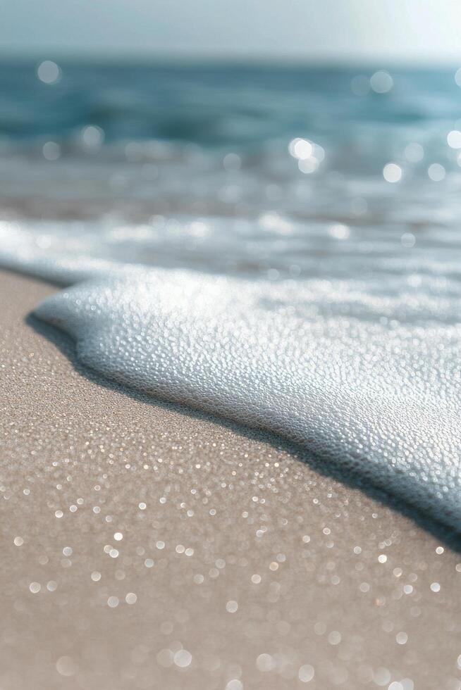 Gentle waves wash ashore on a serene beach with sparkling sand and clear blue water photo