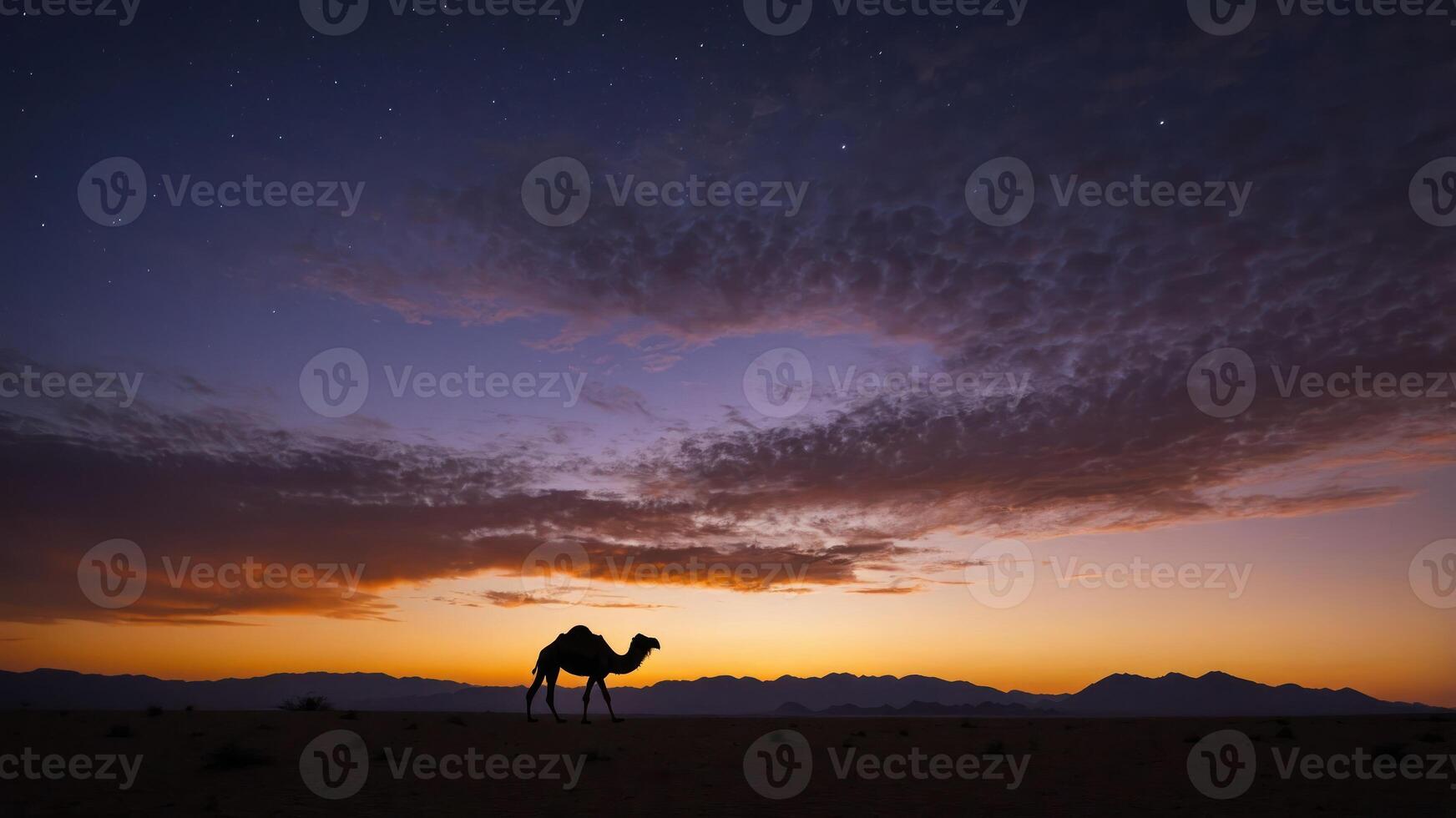 A silhouette of a camel against a vibrant sunset in a desert landscape. photo