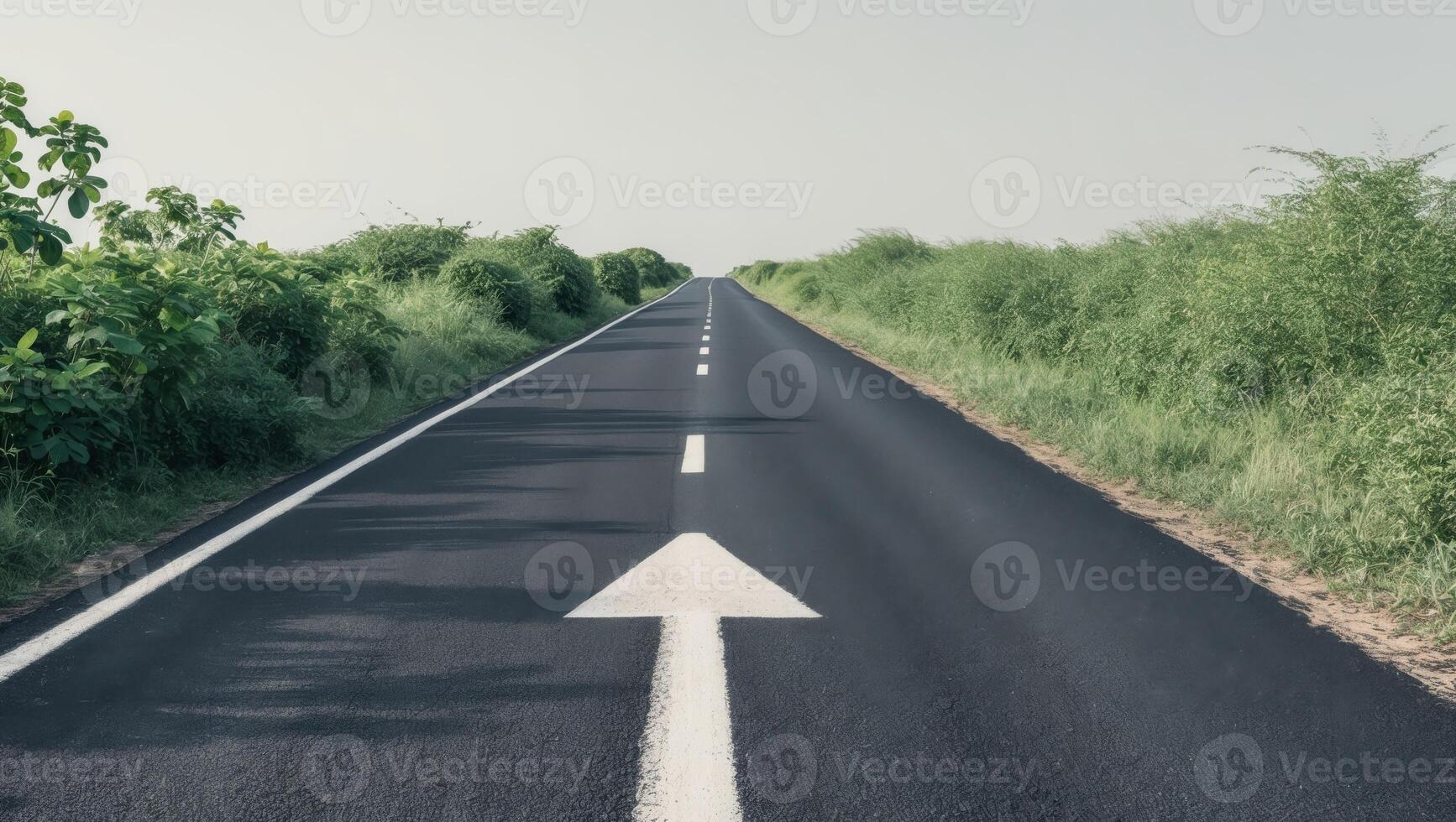An empty road with an arrow pointing in the direction of the future photo