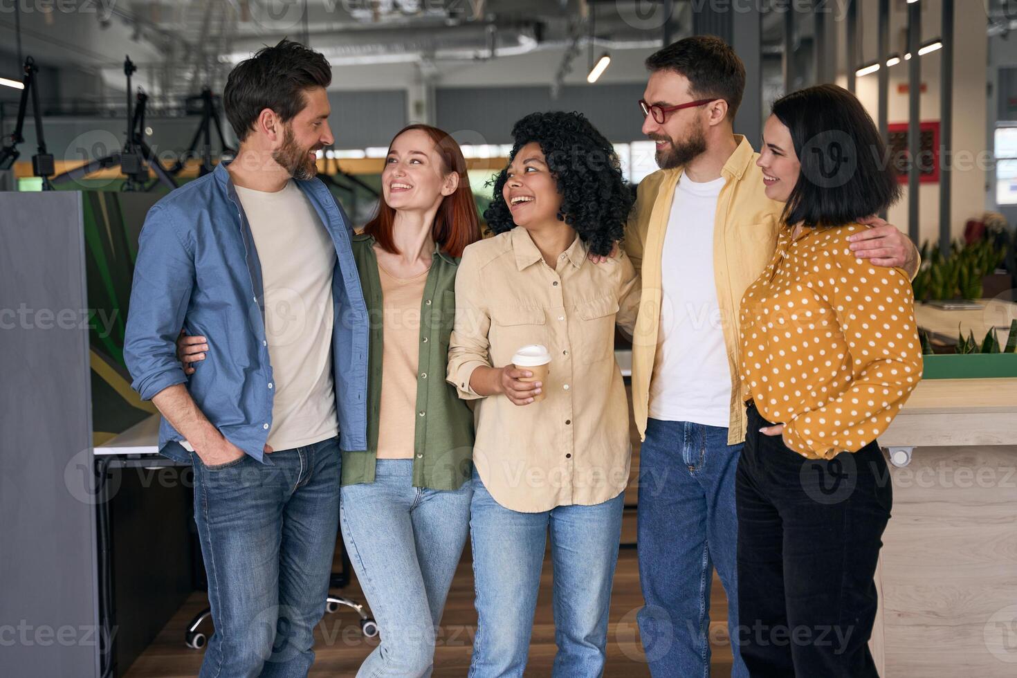 Diverse team of managers having fun in the office during a break photo