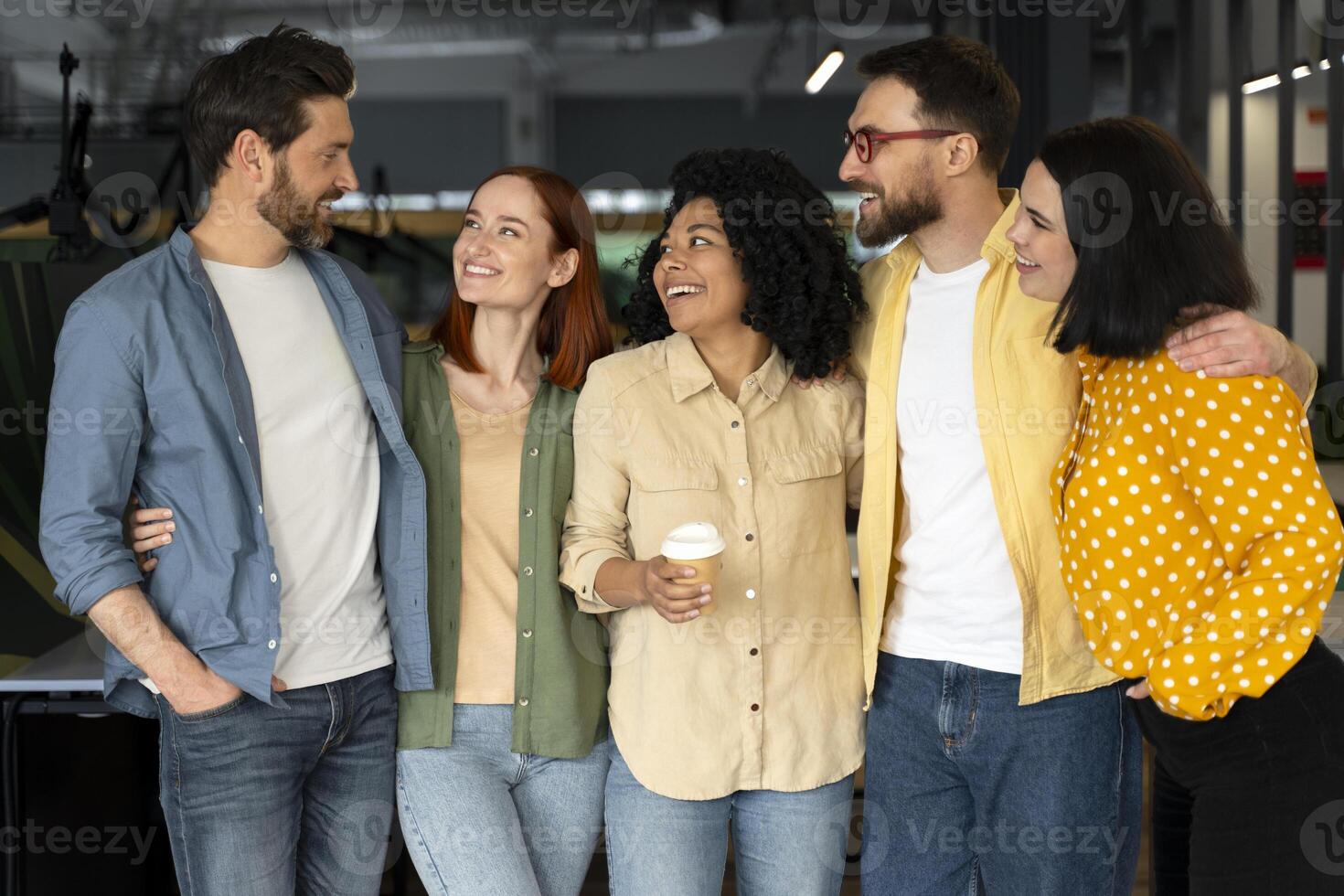 Diverse business team enjoying a coffee break together in the office photo