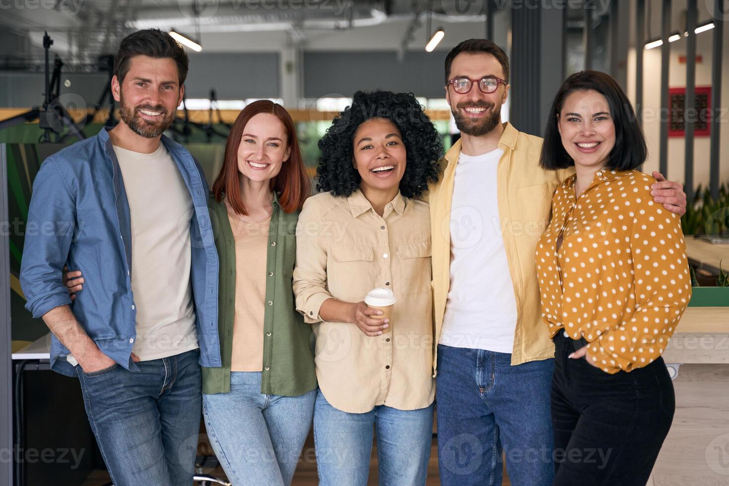 Group of diverse business people smiling while standing in office photo