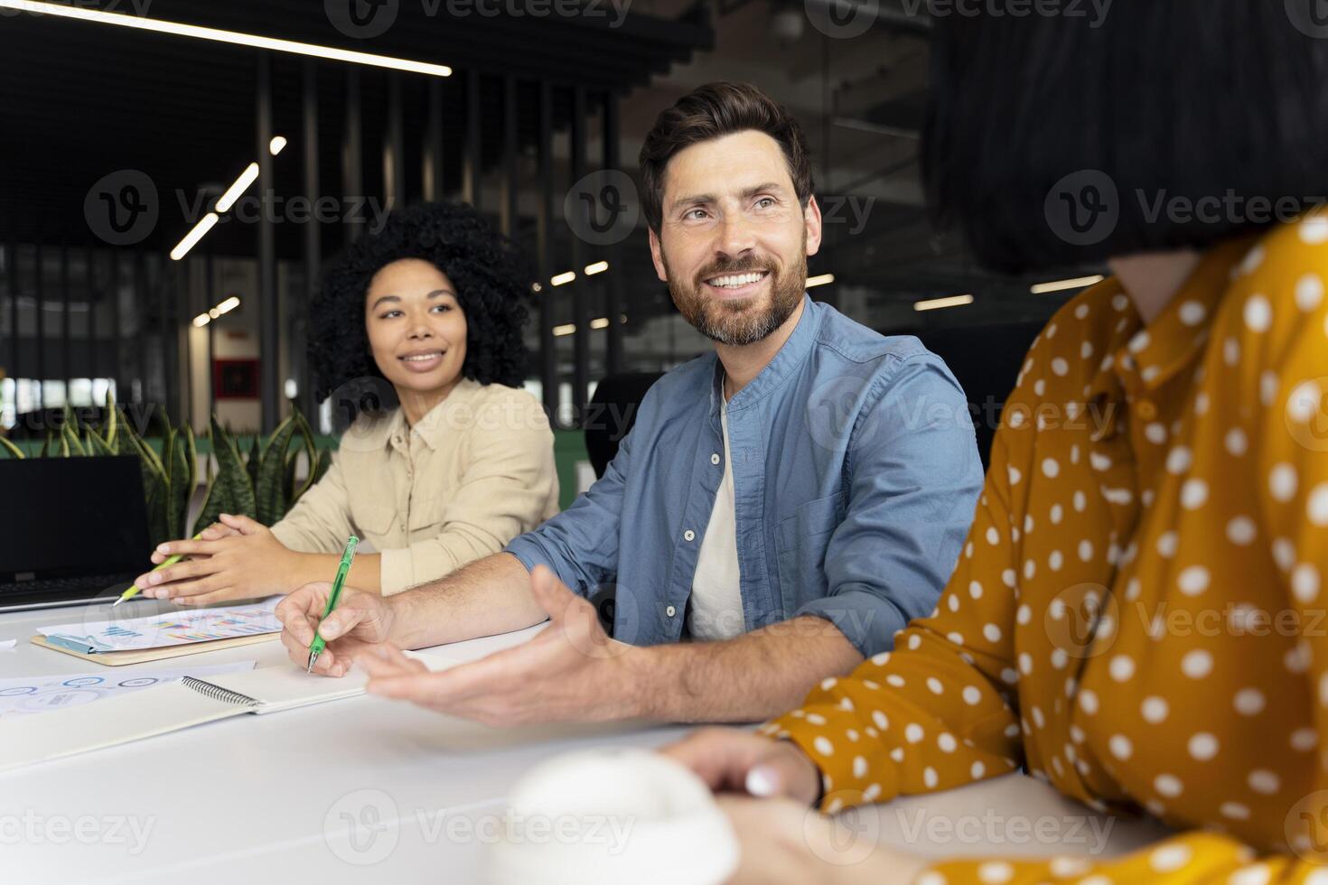 Marketing team having brainstorming session discussing new project in modern office photo