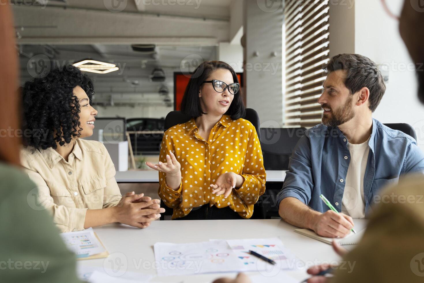 Businesswoman leading a brainstorming meeting with her team in the office photo