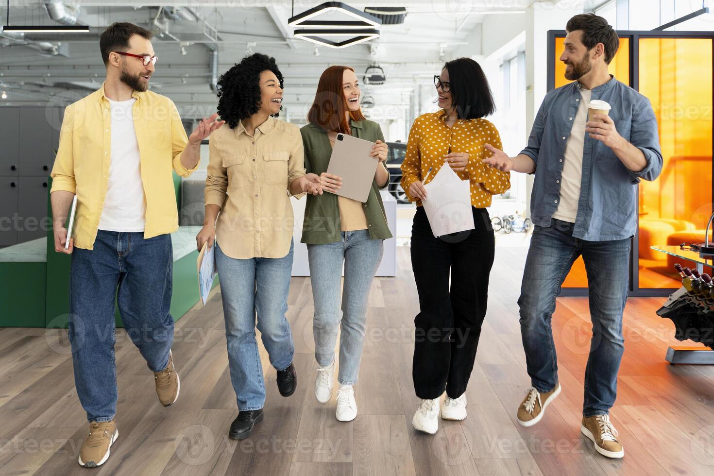 Group of diverse business people walking and talking in modern office photo