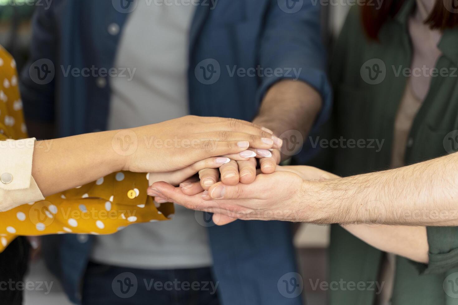 Business team joining hands for teamwork and support photo