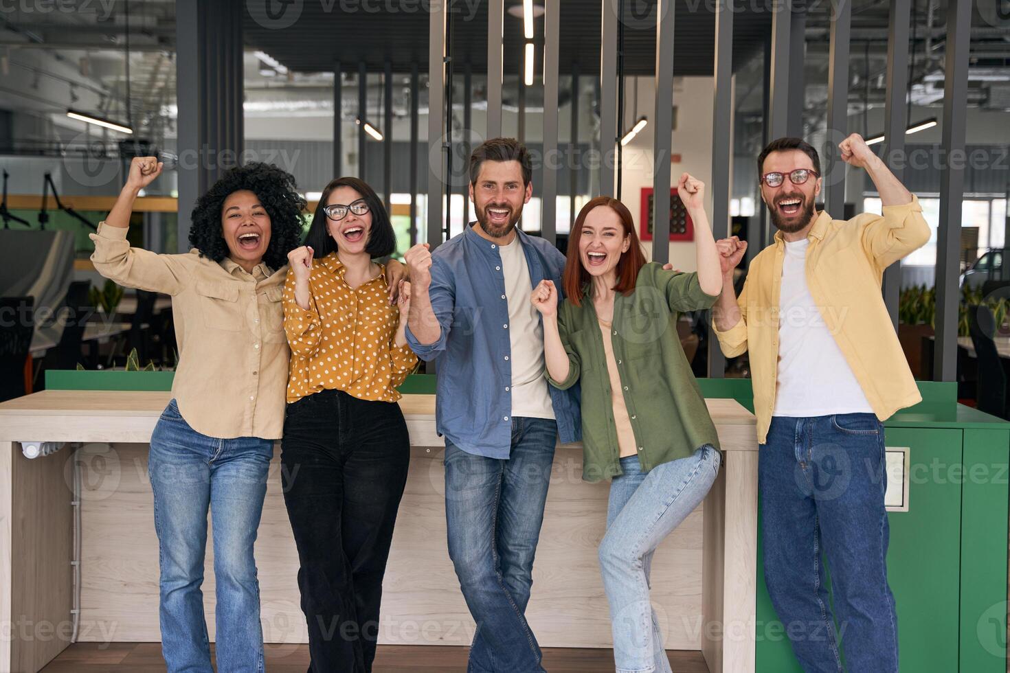 Successful business team celebrating victory in modern office photo