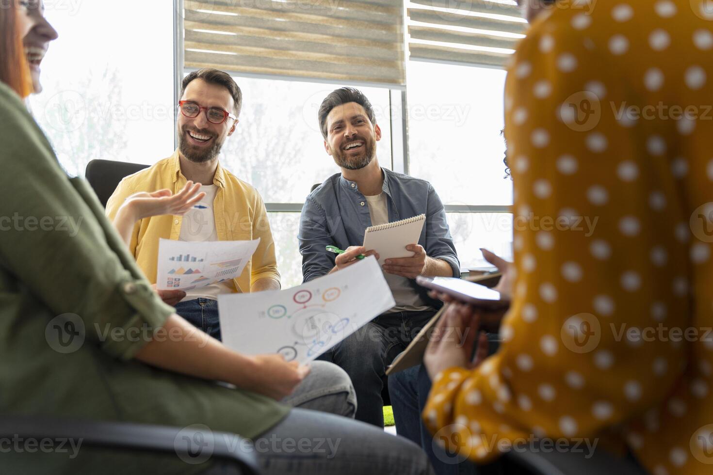 Marketing team having a productive meeting discussing charts and reports photo