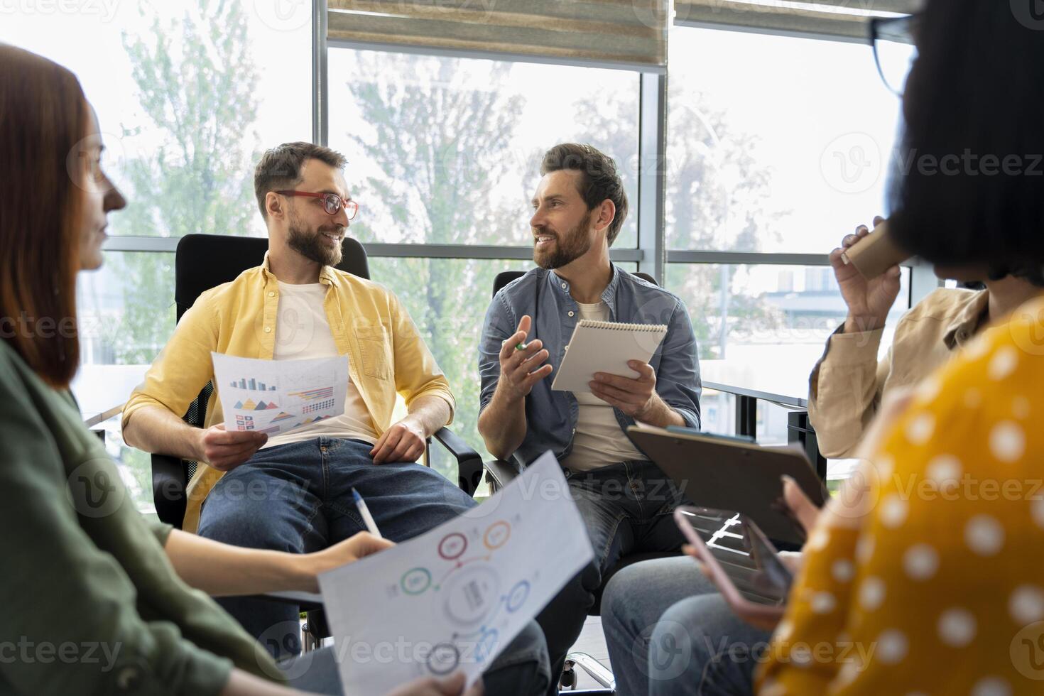 Creative business team brainstorming discussing business ideas using charts and graphs photo