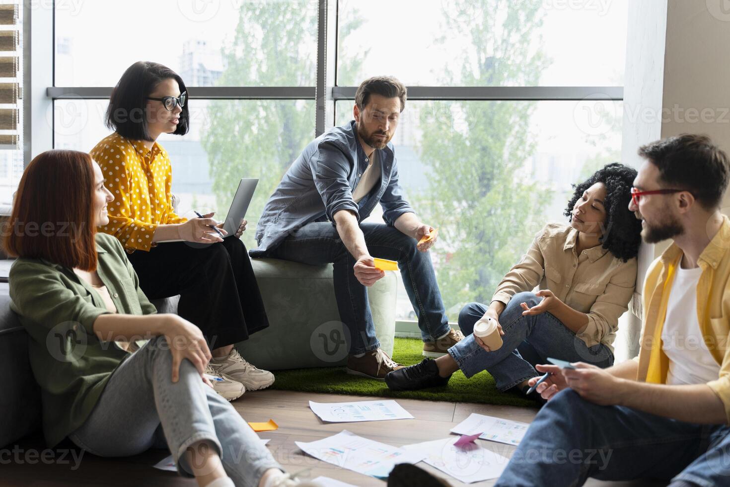 Diverse team of professionals brainstorming using sticky notes photo