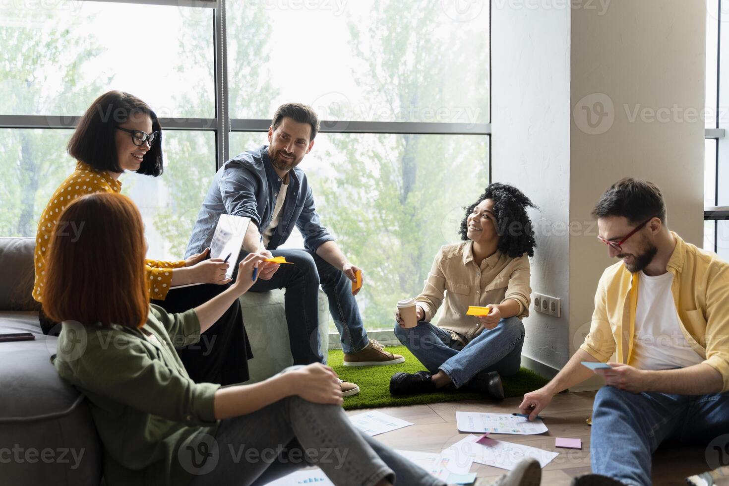 Team of creative designers brainstorming during meeting photo