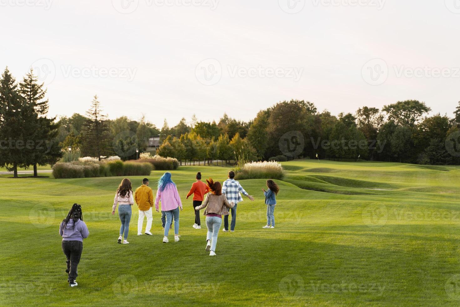 Group of friends walking on golf course celebrating event photo
