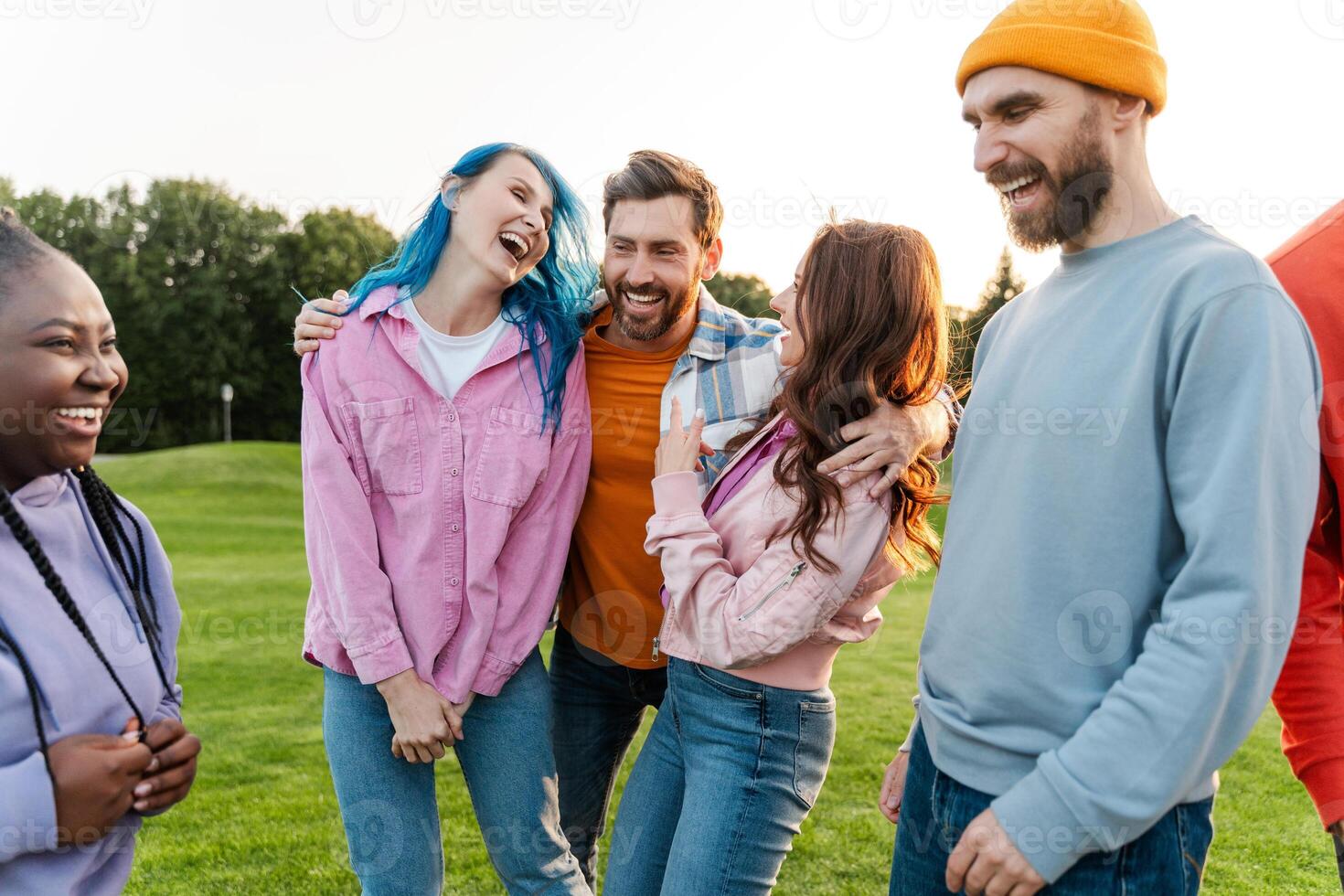 Group of friends having fun and laughing together outdoors photo