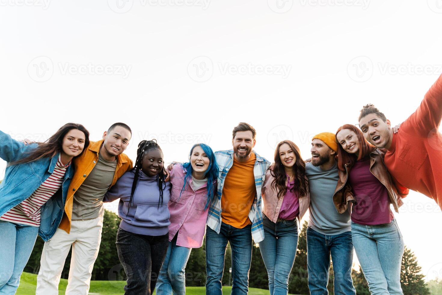 Group of friends is hugging in the park and having fun photo