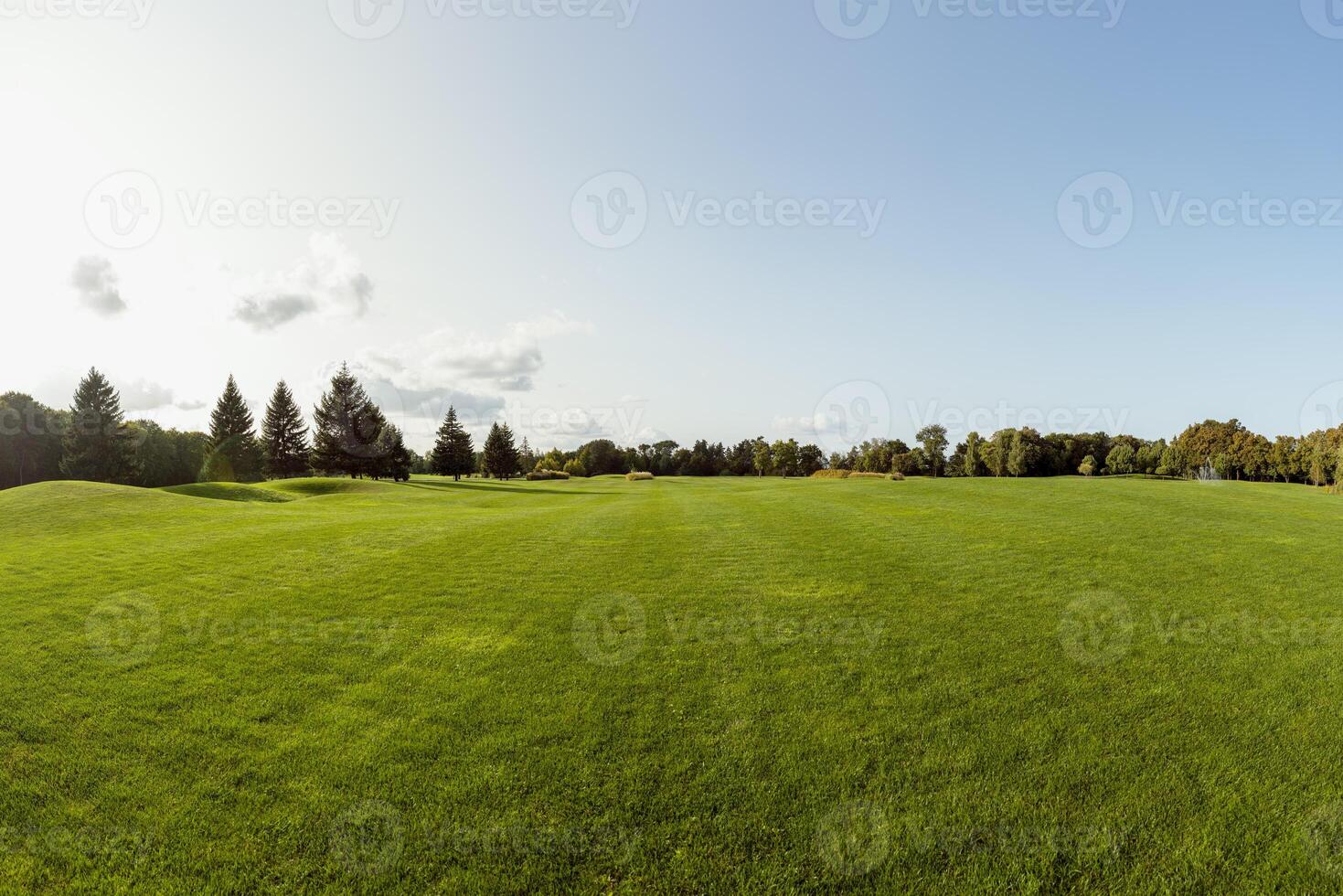 Empty golf course stretching into the distance on a sunny day photo
