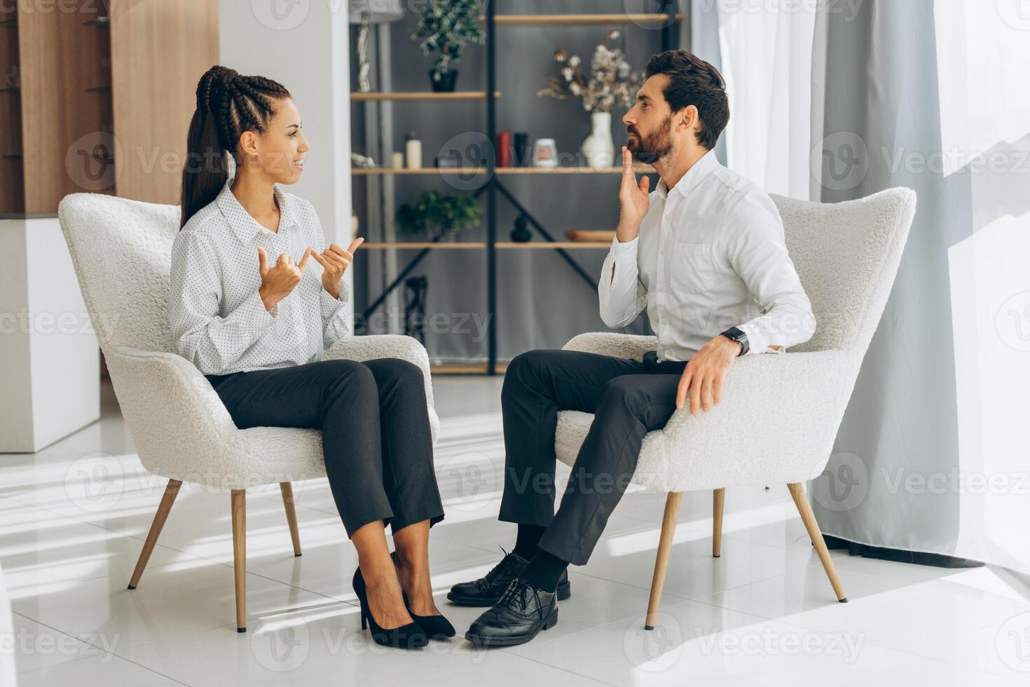 Portrait of middle aged, smiling Latin man and woman, wearing modern casual clothes gesturing photo