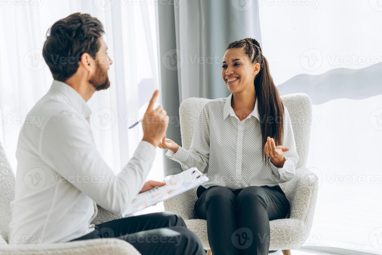 Portrait of happy, smiling professional doctor, psychologist talking with attractive woman photo