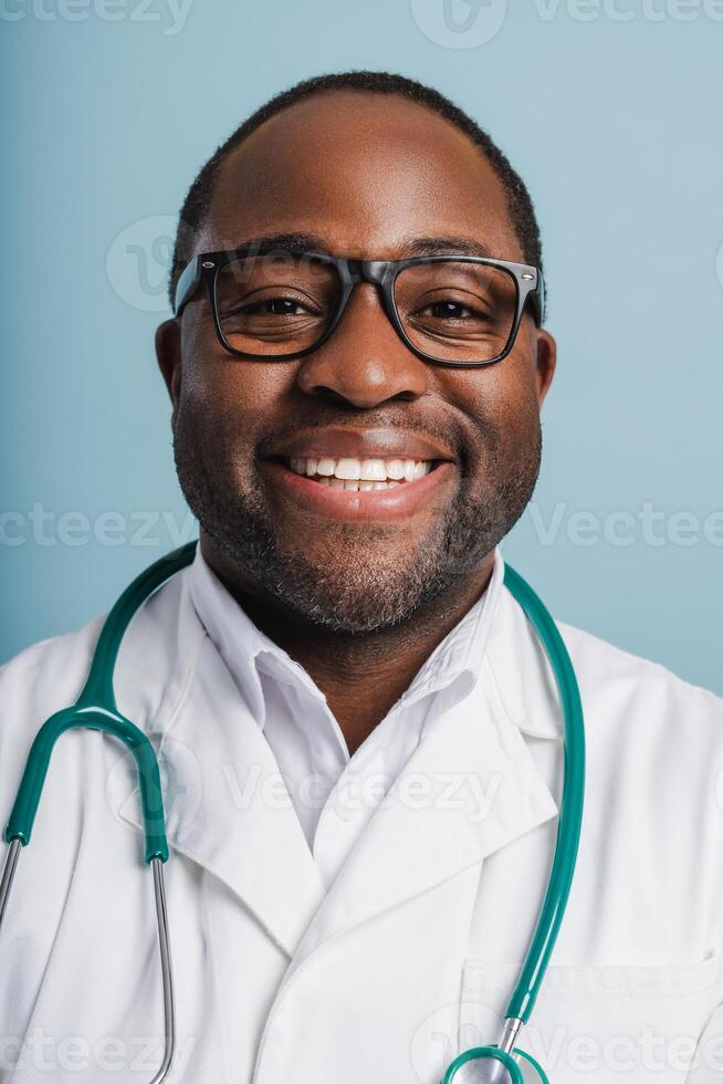 Happy professional medical worker in glasses with stethoscope looking at camera in studio photo