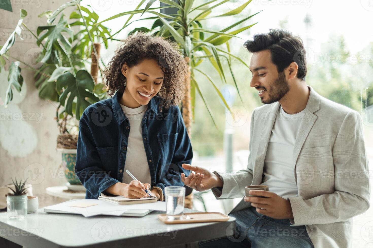 Business meeting in a cafe, two professionals discussing a project photo