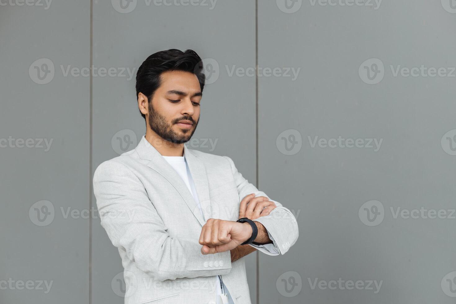 Businessman checking time on smartwatch in urban setting photo