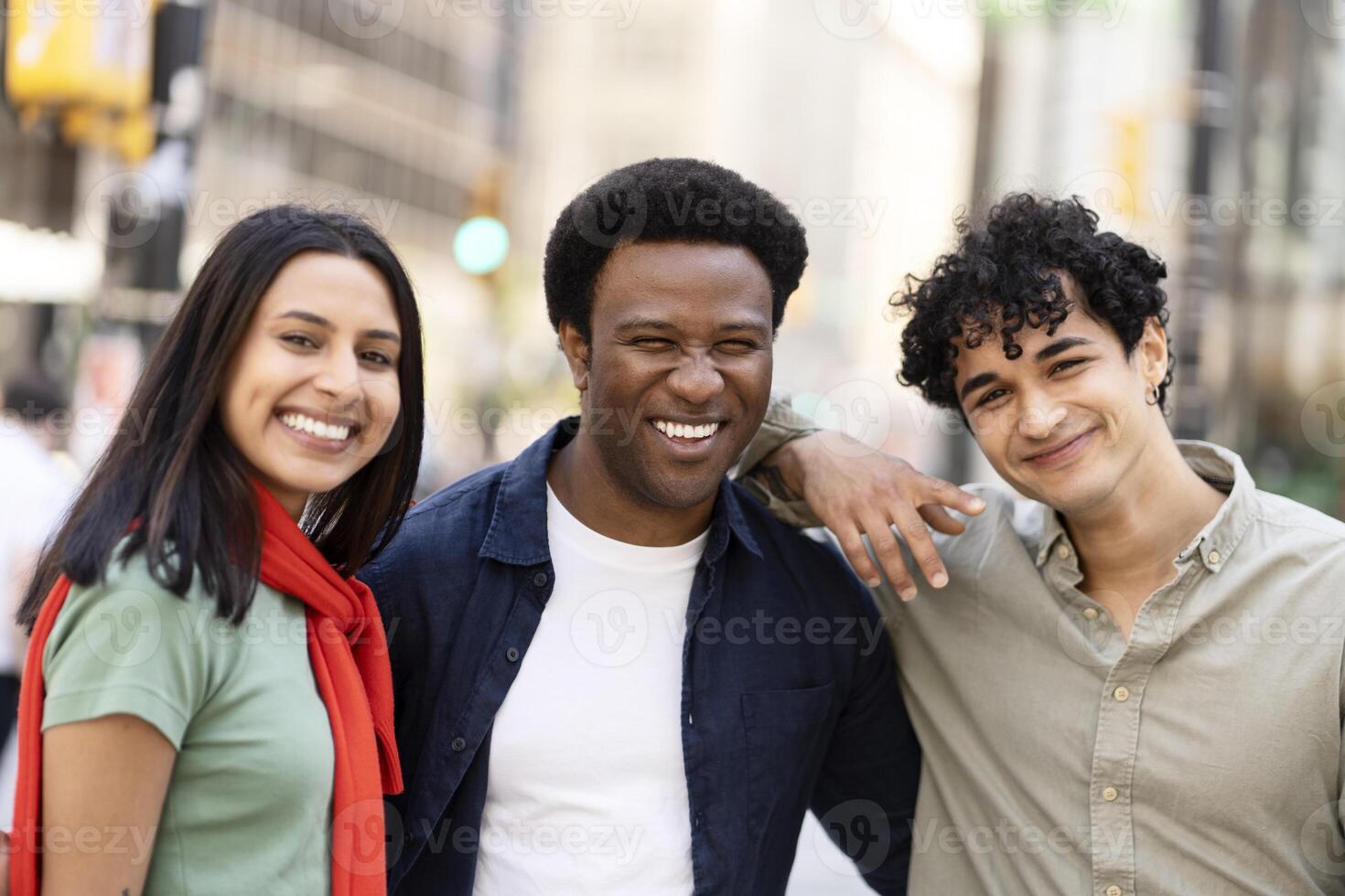 Group of friends is smiling in a big city street photo