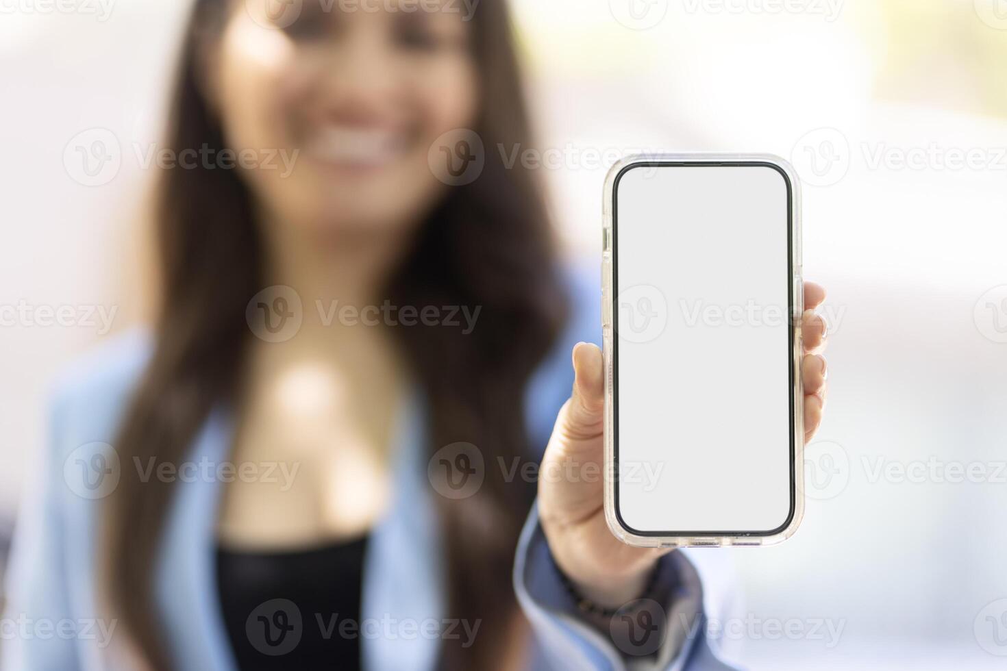 Businesswoman showing smartphone with blank screen for mobile app design photo