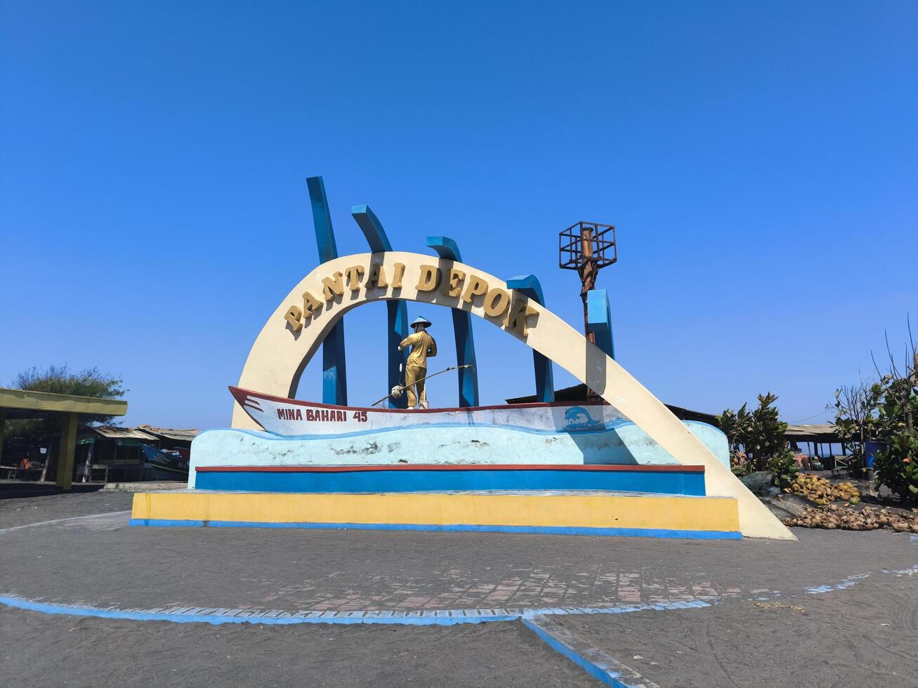 Monument at the entrance to Depok beach, Bantul, where fishermen sell marine products in the form of fish, shellfish, crabs, shrimp and lobster. photo