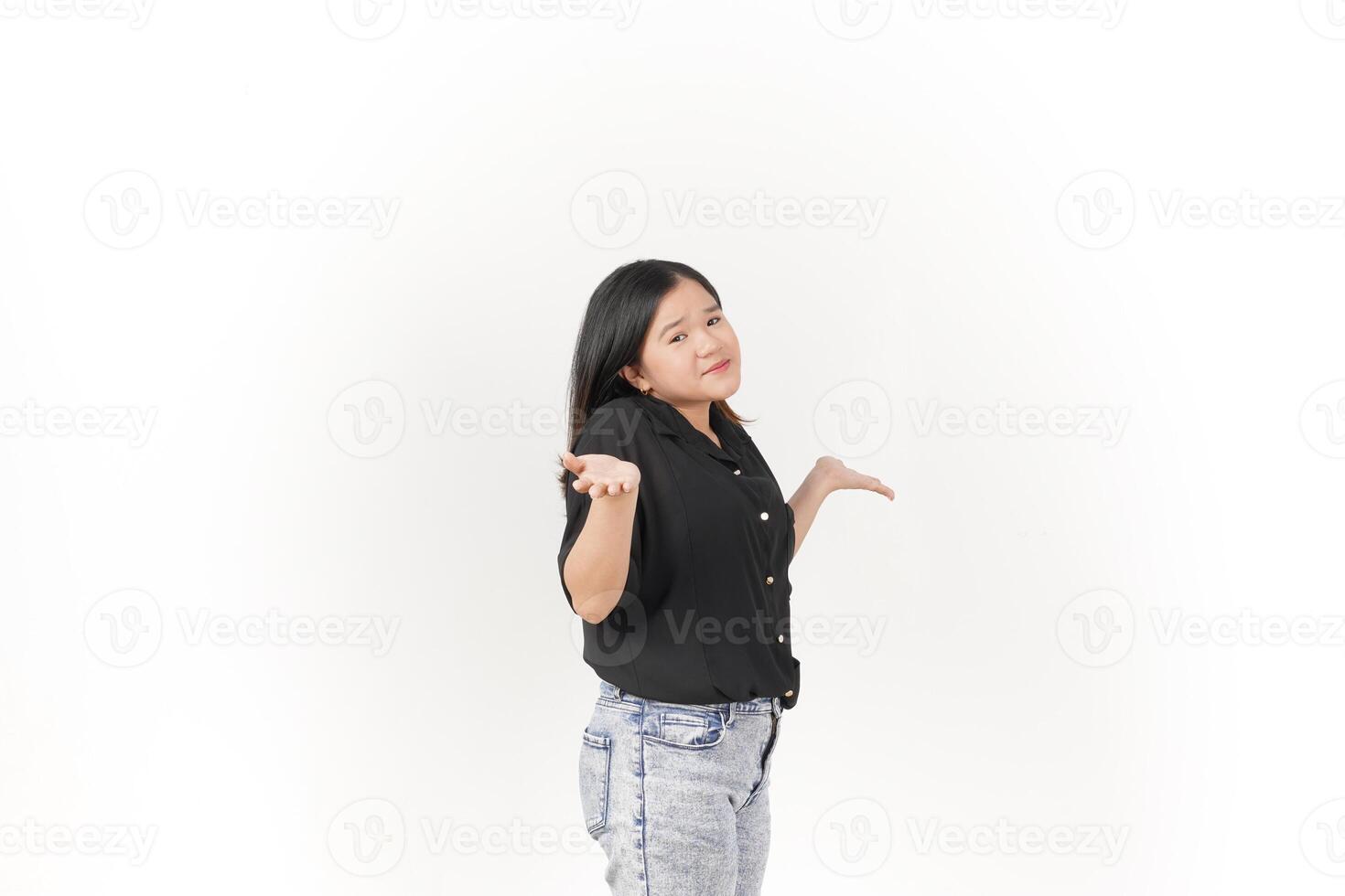 beautiful Asian woman strikes a wondering pose, arms spread wide in a questioning gesture against a white background photo