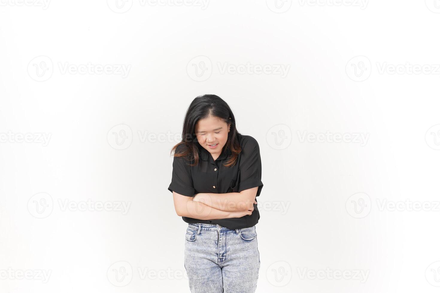 beautiful Asian woman grimaces in pain, clutching her stomach, against a clean white background photo