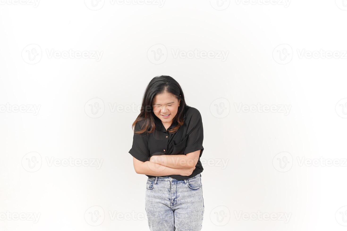 beautiful Asian woman grimaces in pain, clutching her stomach, against a clean white background photo