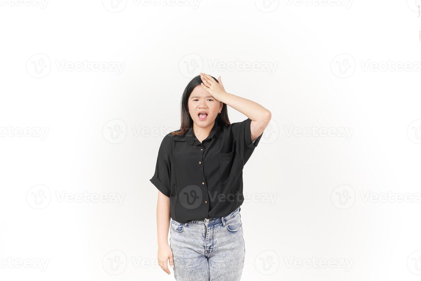 beautiful Asian woman holds her head in pain, with a pained expression showing signs of a headache against a white background photo