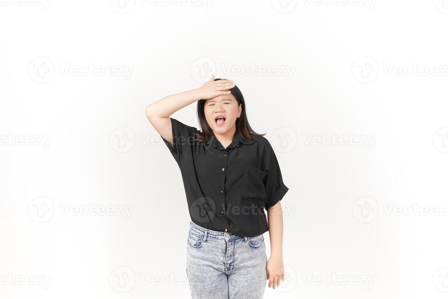beautiful Asian woman holds her head in pain, with a pained expression showing signs of a headache against a white background photo
