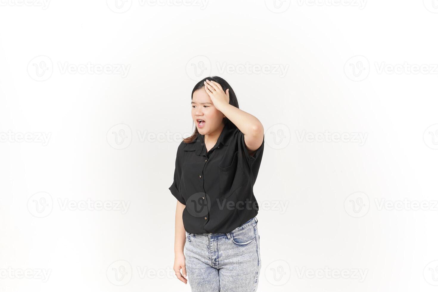 beautiful Asian woman holds her head in pain, with a pained expression showing signs of a headache against a white background photo