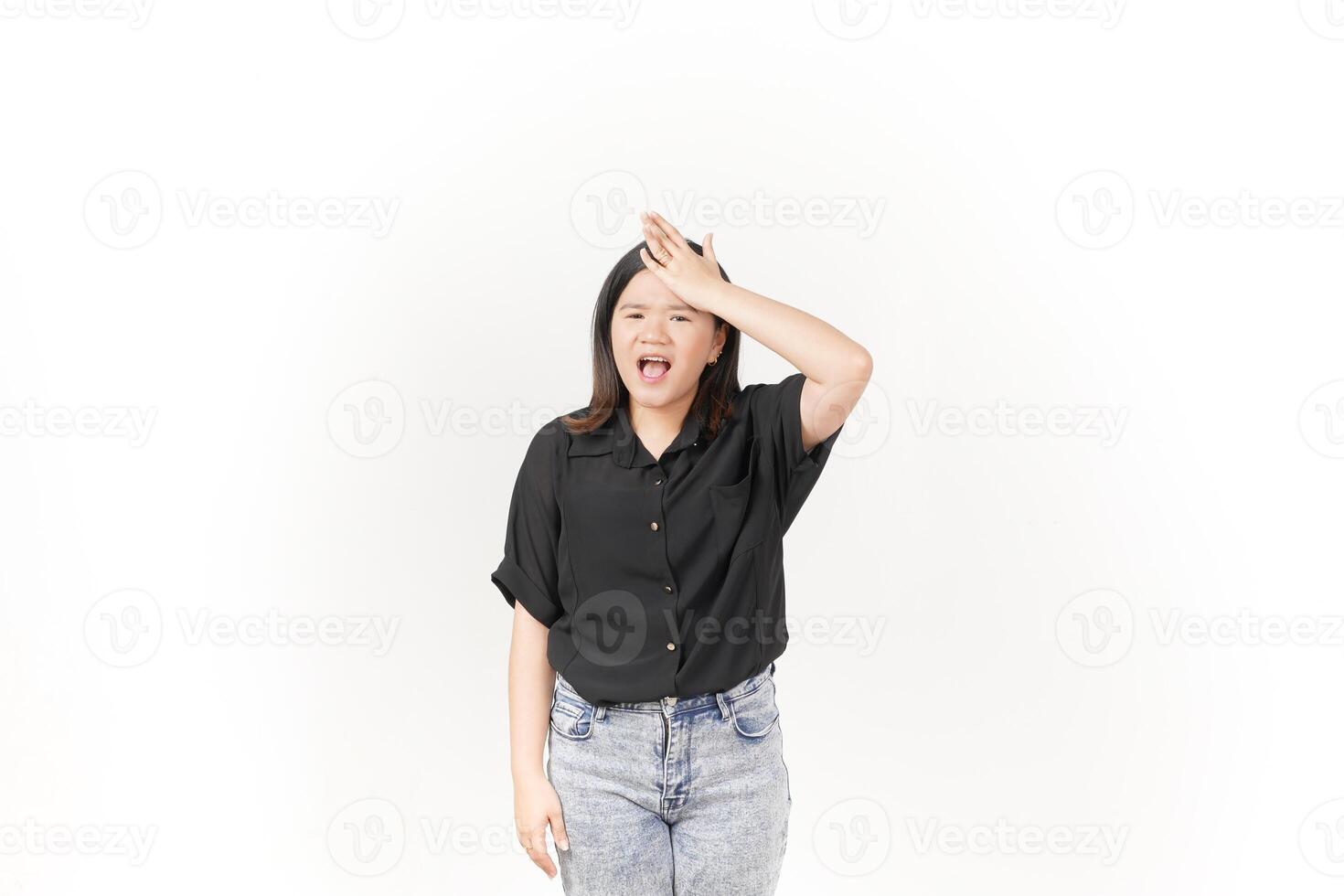 beautiful Asian woman holds her head in pain, with a pained expression showing signs of a headache against a white background photo