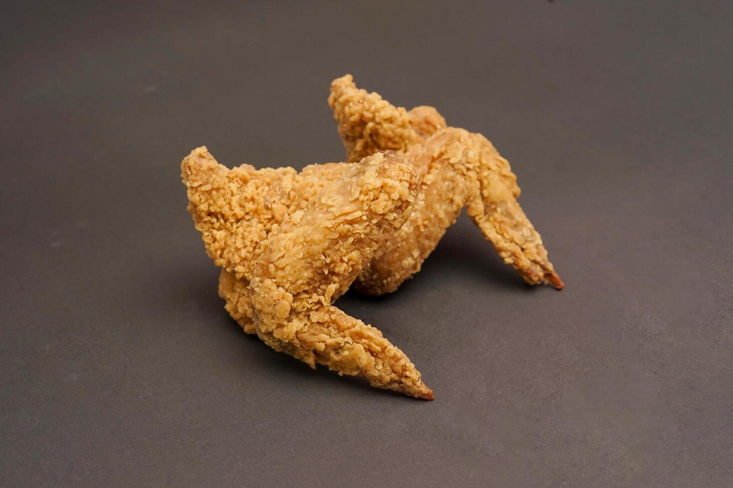 Fried Chicken breast hot crispy strips crunchy chicken tenders three pieces isolated on black background. Crispy fried chicken is a food made from fried chicken placed on a plate. photo