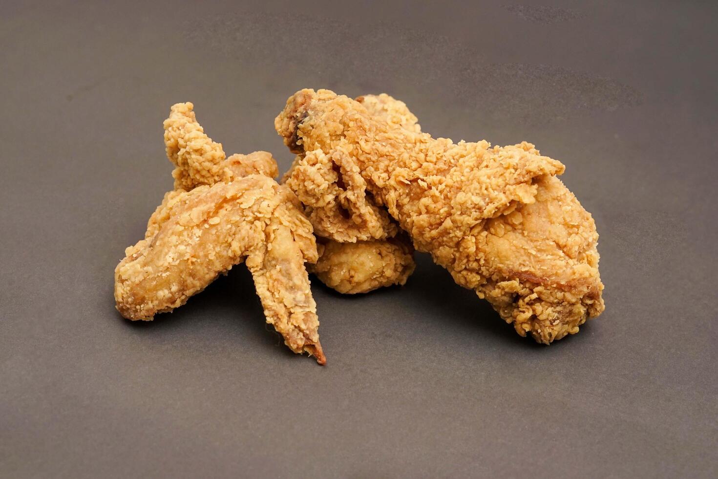 Fried Chicken breast hot crispy strips crunchy chicken tenders three pieces isolated on black background. Crispy fried chicken is a food made from fried chicken placed on a plate. photo