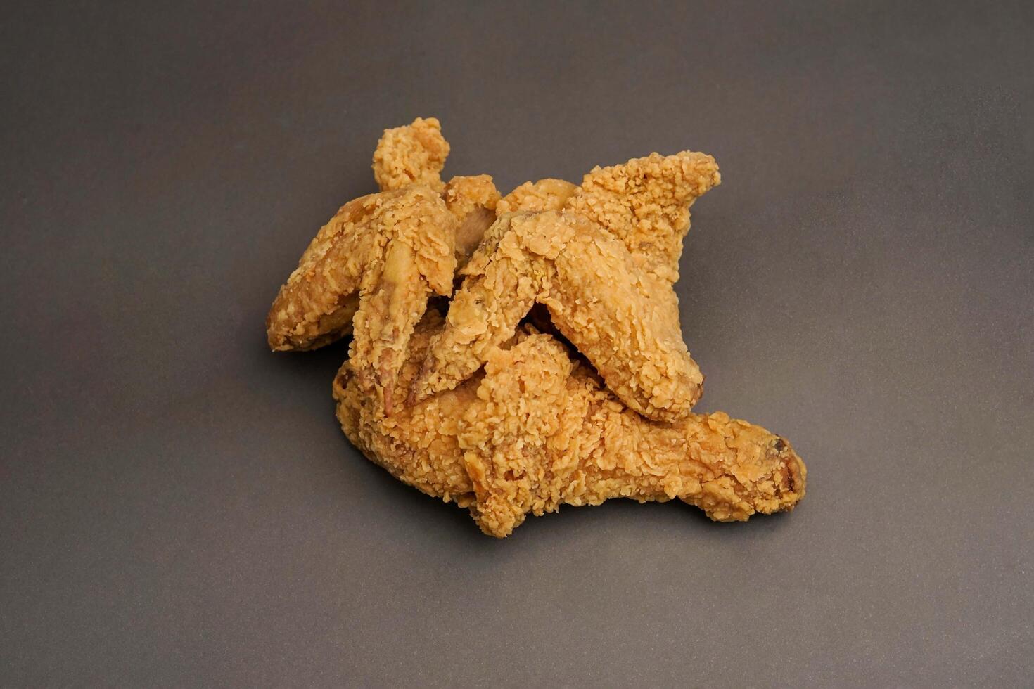 Fried Chicken breast hot crispy strips crunchy chicken tenders three pieces isolated on black background. Crispy fried chicken is a food made from fried chicken placed on a plate. photo