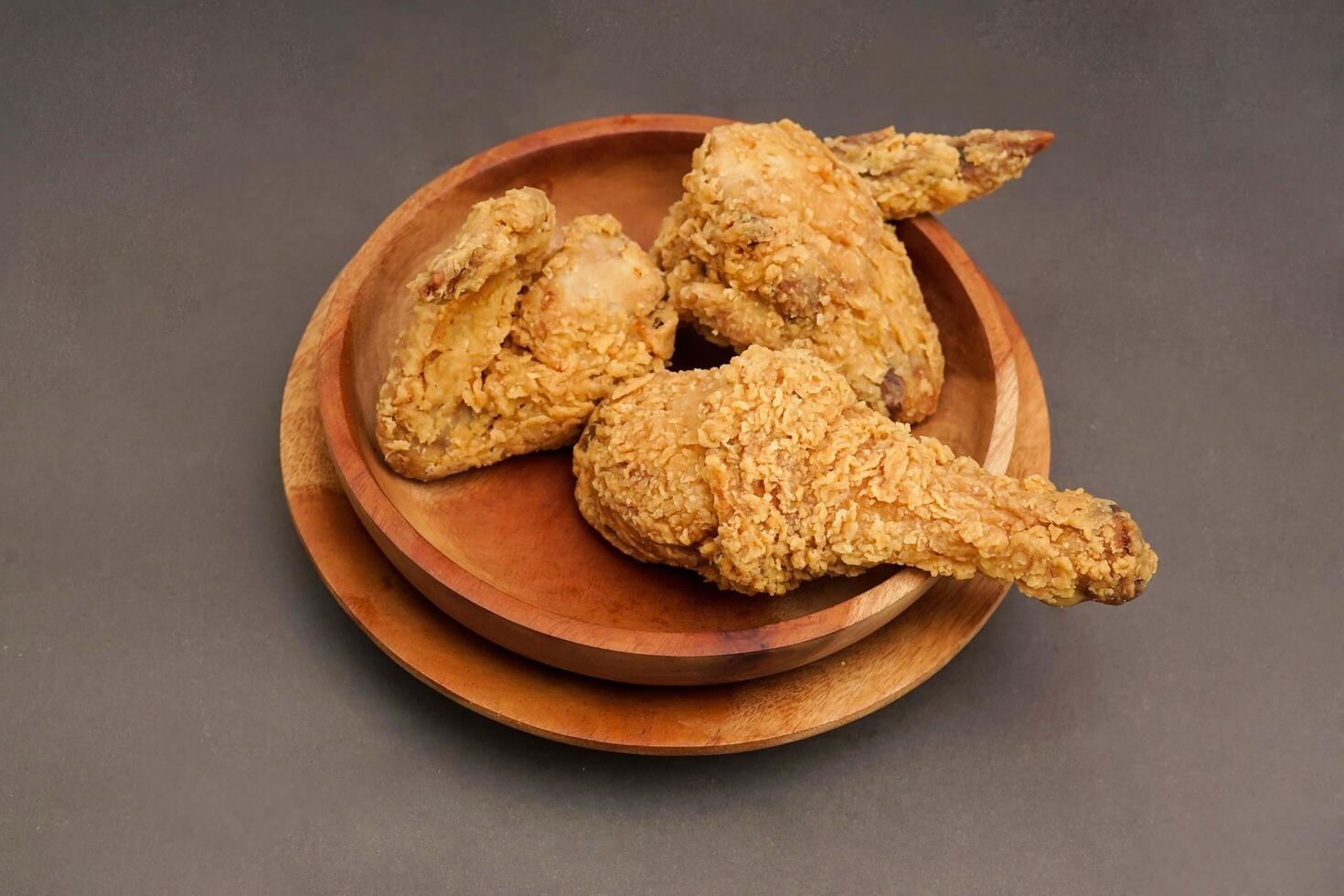 Fried Chicken breast hot crispy strips crunchy chicken tenders three pieces isolated on black background. Crispy fried chicken is a food made from fried chicken placed on a plate. photo