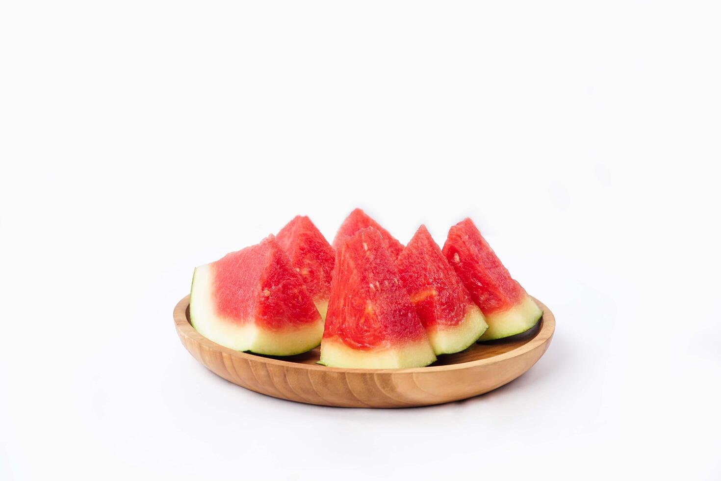 Whole watermelon and seeded slices seen front and top on a white background. Watermelon slices are red, seedy and juicy. photo