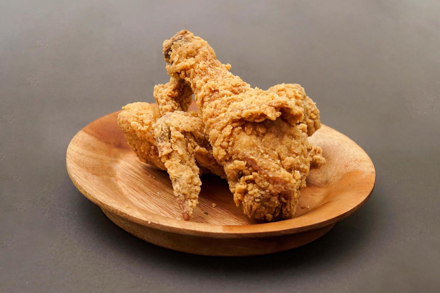 Fried Chicken breast hot crispy strips crunchy chicken tenders three pieces isolated on black background. Crispy fried chicken is a food made from fried chicken placed on a plate. photo