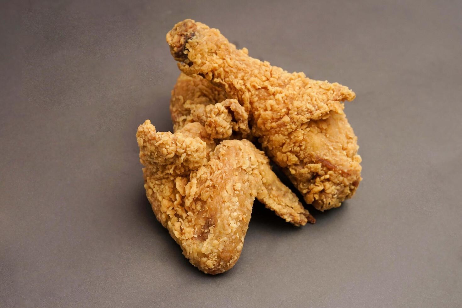 Fried Chicken breast hot crispy strips crunchy chicken tenders three pieces isolated on black background. Crispy fried chicken is a food made from fried chicken placed on a plate. photo