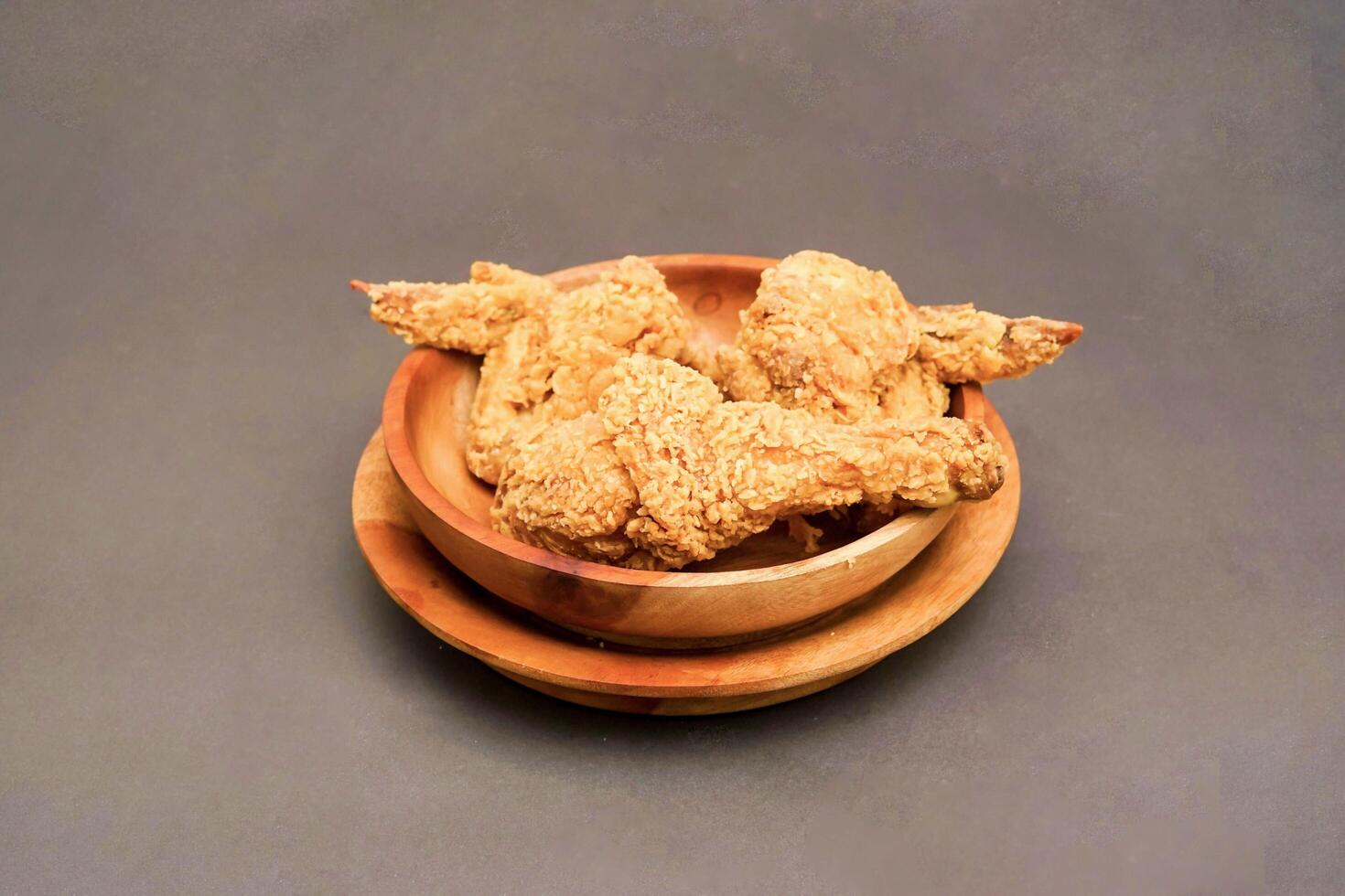 Fried Chicken breast hot crispy strips crunchy chicken tenders three pieces isolated on black background. Crispy fried chicken is a food made from fried chicken placed on a plate. photo