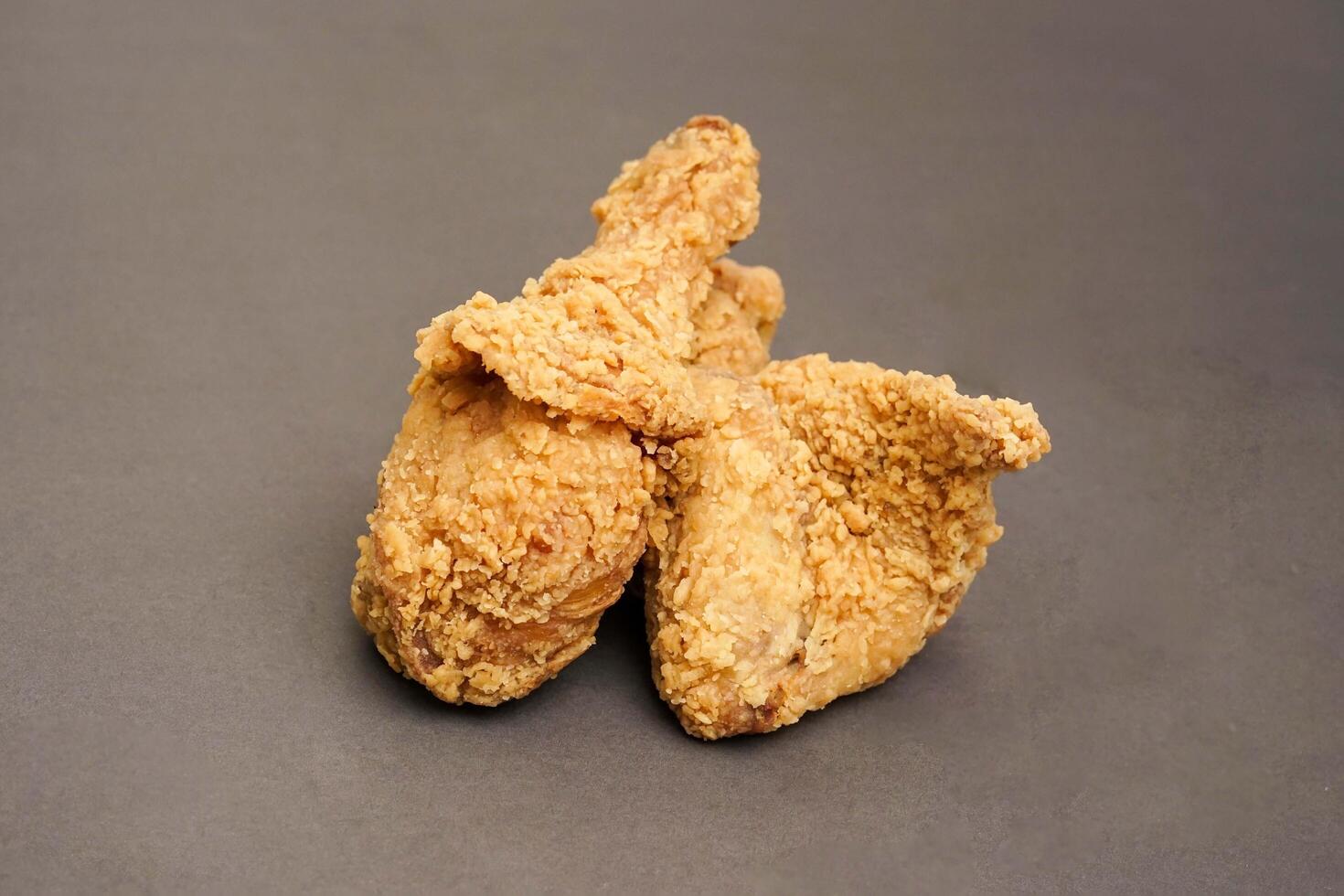 Fried Chicken breast hot crispy strips crunchy chicken tenders three pieces isolated on black background. Crispy fried chicken is a food made from fried chicken placed on a plate. photo