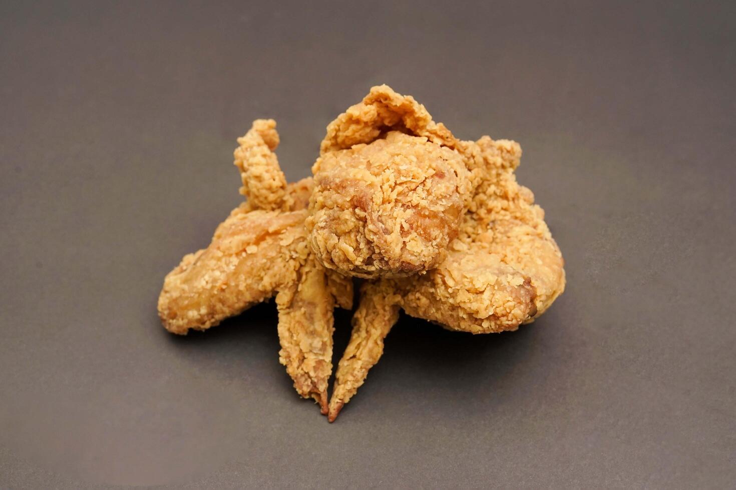 Fried Chicken breast hot crispy strips crunchy chicken tenders three pieces isolated on black background. Crispy fried chicken is a food made from fried chicken placed on a plate. photo