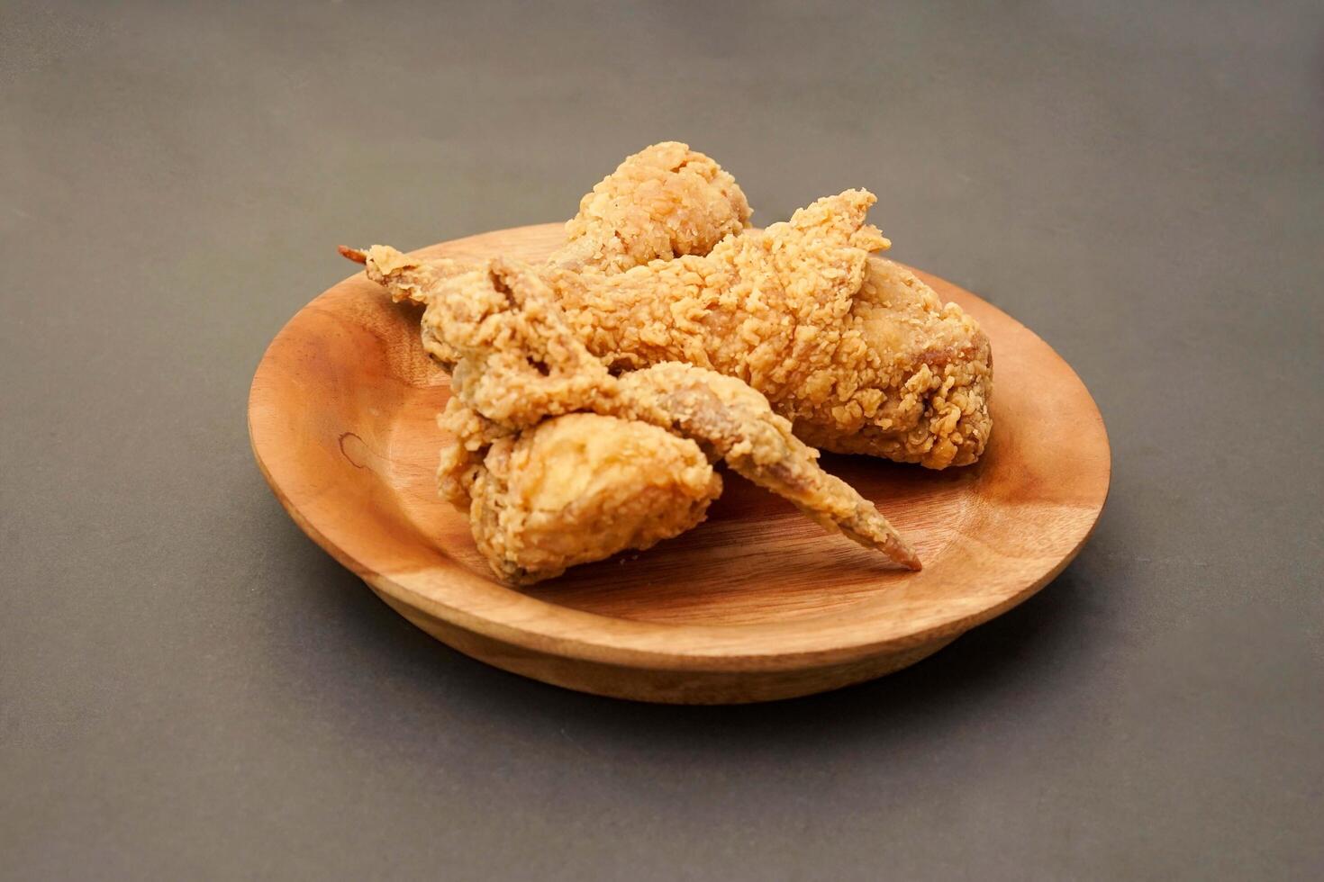 Fried Chicken breast hot crispy strips crunchy chicken tenders three pieces isolated on black background. Crispy fried chicken is a food made from fried chicken placed on a plate. photo