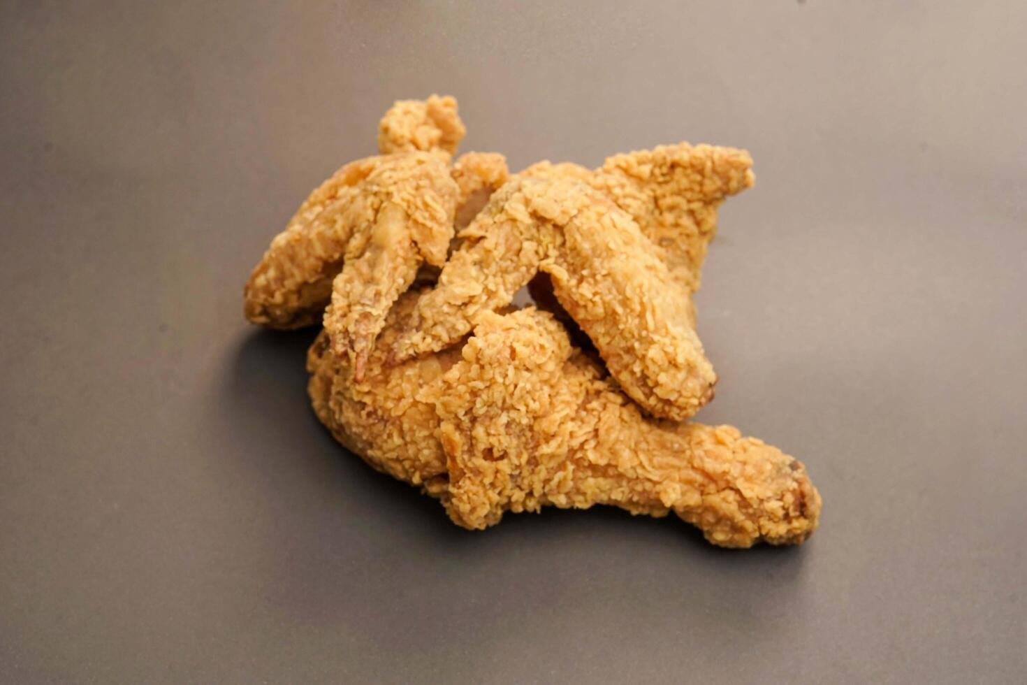 Fried Chicken breast hot crispy strips crunchy chicken tenders three pieces isolated on black background. Crispy fried chicken is a food made from fried chicken placed on a plate. photo