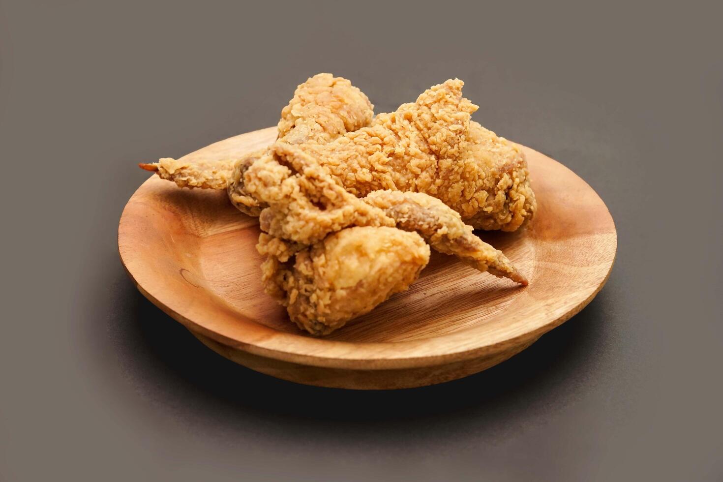 Fried Chicken breast hot crispy strips crunchy chicken tenders three pieces isolated on black background. Crispy fried chicken is a food made from fried chicken placed on a plate. photo