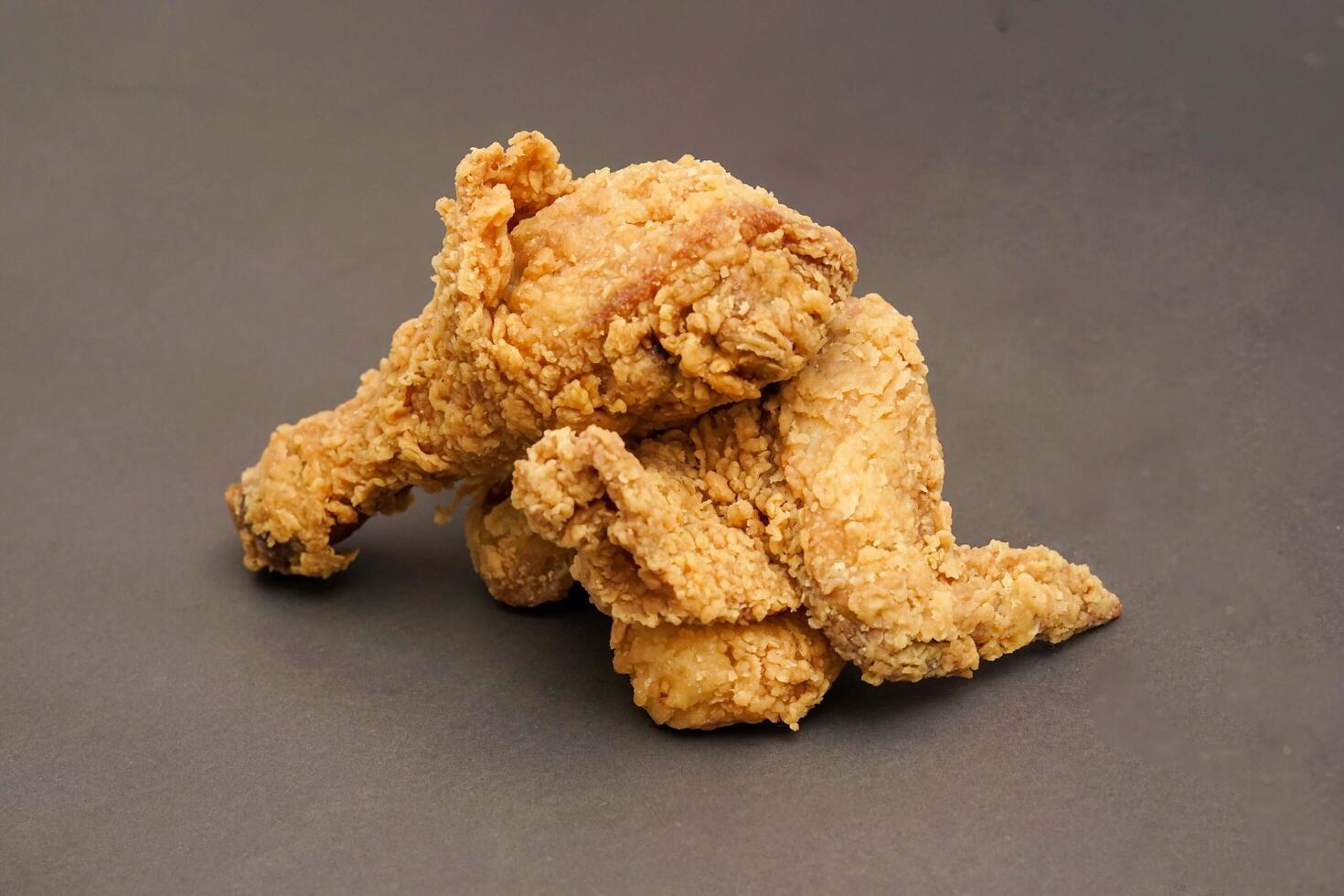 Fried Chicken breast hot crispy strips crunchy chicken tenders three pieces isolated on black background. Crispy fried chicken is a food made from fried chicken placed on a plate. photo