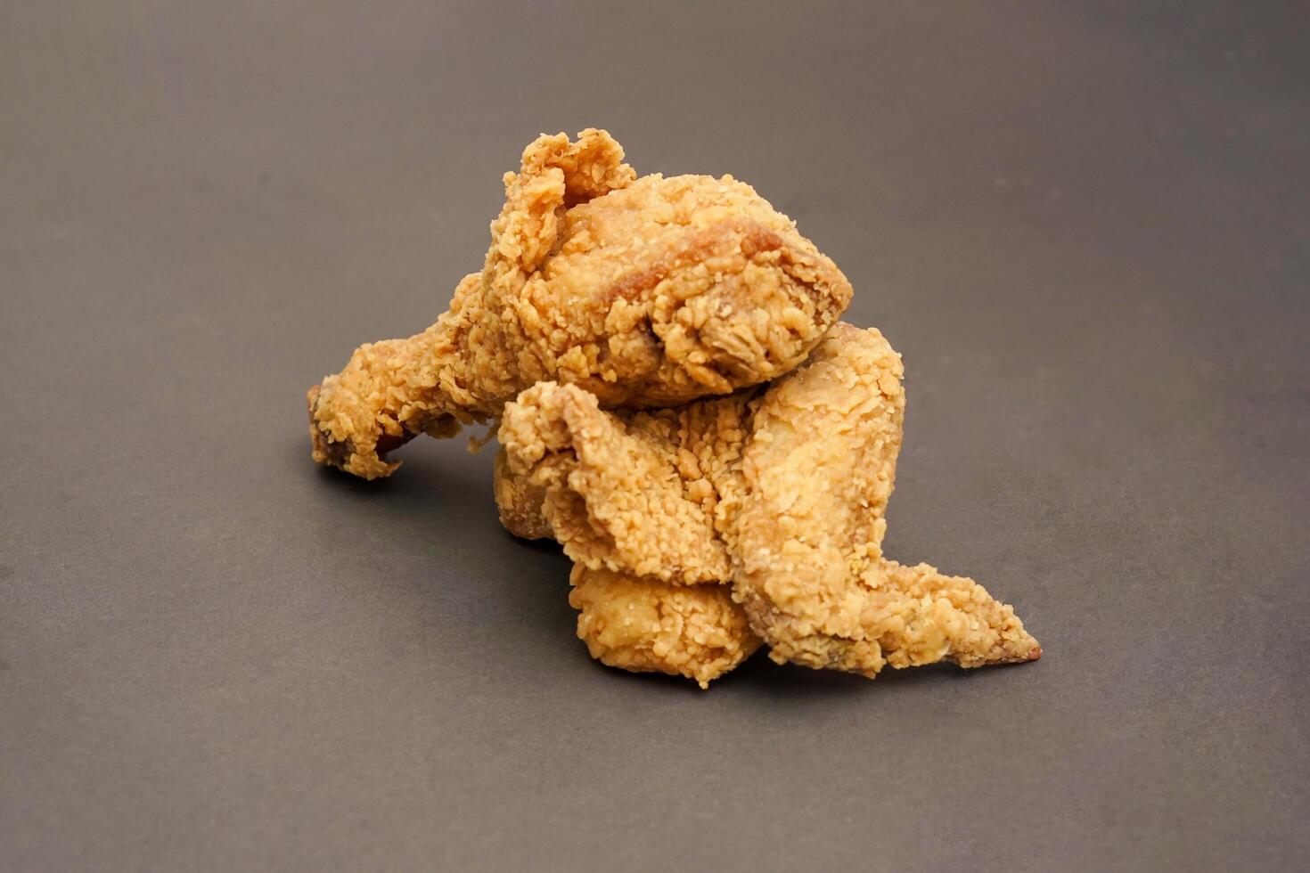 Fried Chicken breast hot crispy strips crunchy chicken tenders three pieces isolated on black background. Crispy fried chicken is a food made from fried chicken placed on a plate. photo
