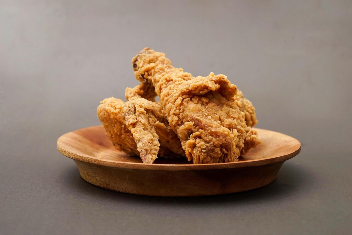 Fried Chicken breast hot crispy strips crunchy chicken tenders three pieces isolated on black background. Crispy fried chicken is a food made from fried chicken placed on a plate. photo